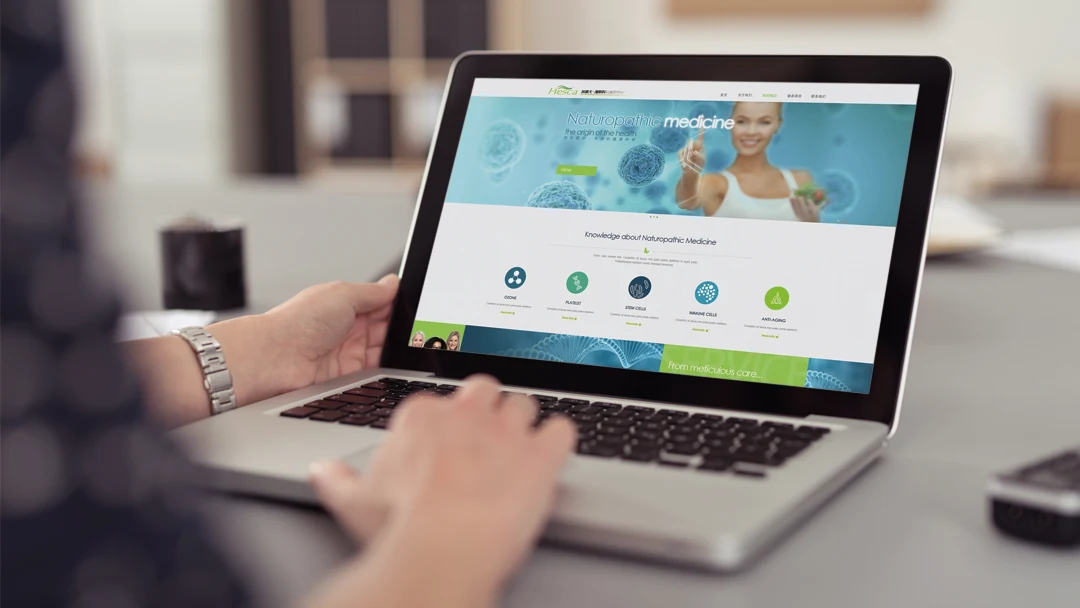 Historical HESCA website design mockup by Focus Media, showing its green brand homepage on a laptop