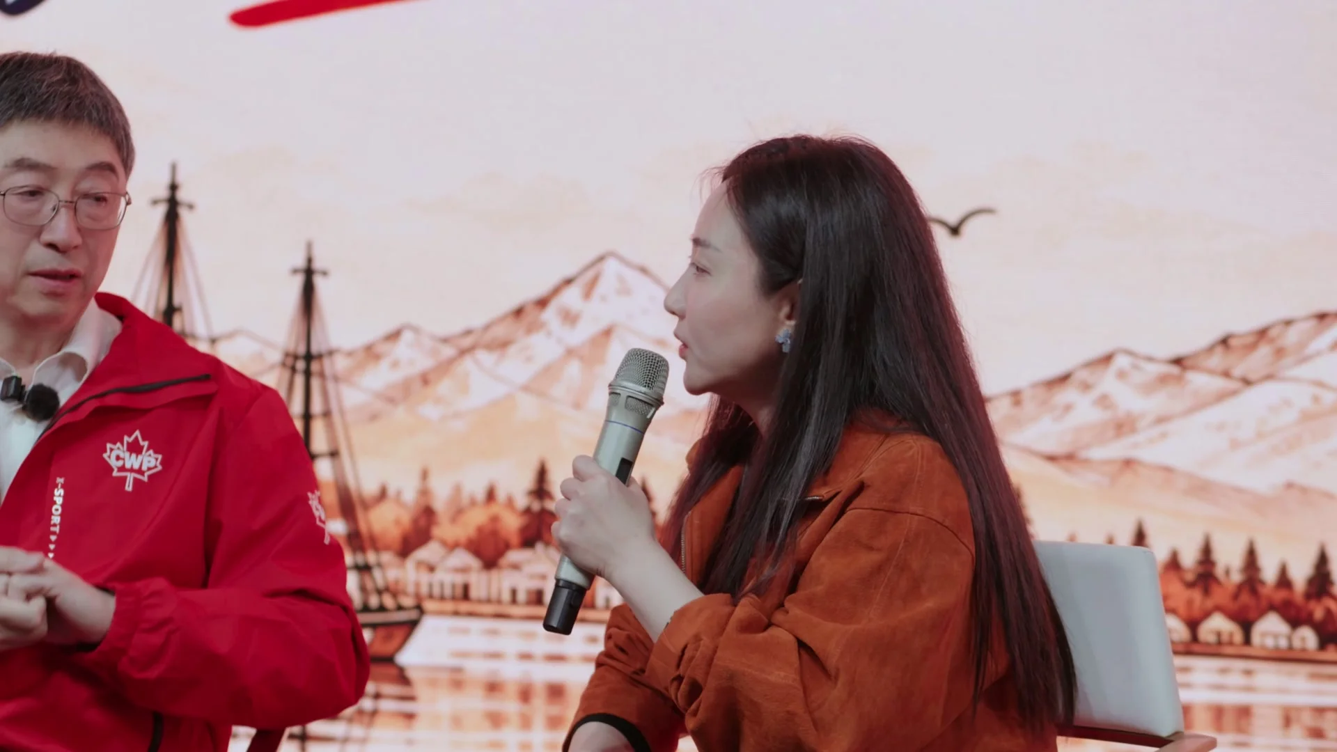 Sarah Yu turns towards Lawrence Chen to ask a question during the live dialogue at Upperland Studio